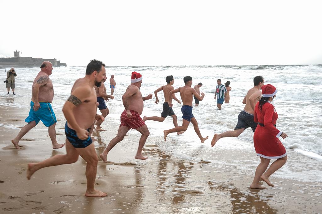 Frio? A tradição cumpriu-se em Carcavelos e dezenas não faltaram ao primeiro mergulho do ano. Foto: Miguel A. Lopes/Lusa