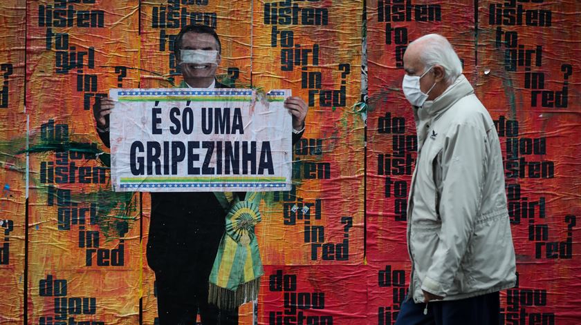 Cartaz critica a forma como o Governo de Bolsonaro lidou com a pandemia. Foto: Fernando Bizerra/EPA